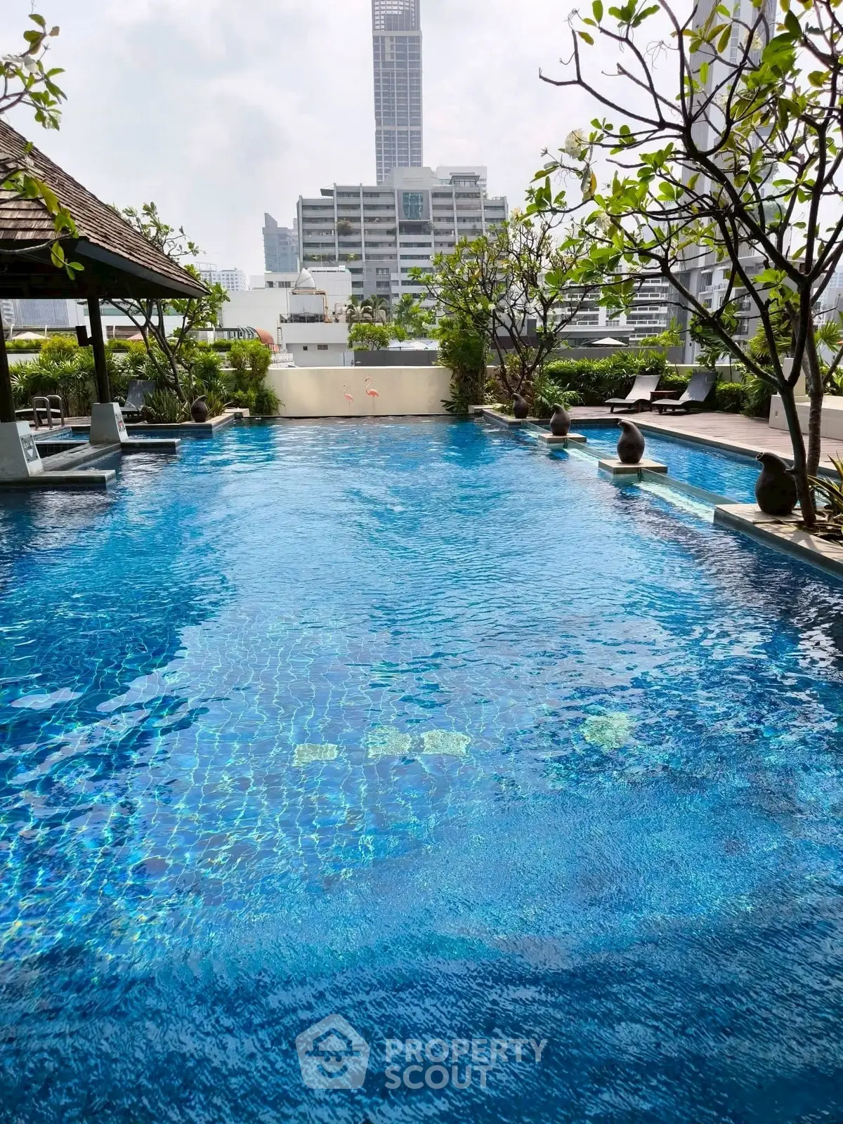 Luxurious rooftop pool with city skyline view, perfect for relaxation and leisure in urban setting.