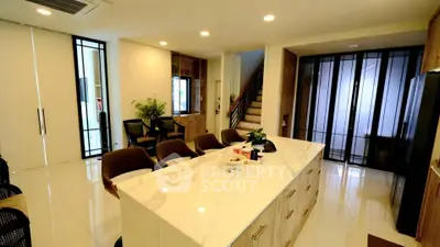 Spacious modern kitchen with marble island and sleek design