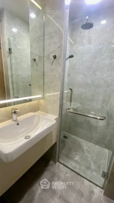 Modern bathroom with sleek glass shower and elegant sink