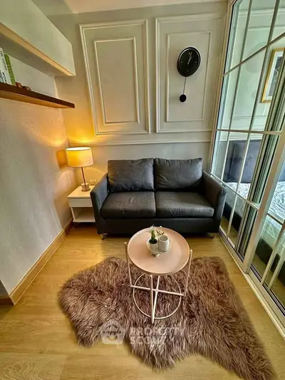 Cozy living room with stylish decor and plush rug, perfect for relaxation.