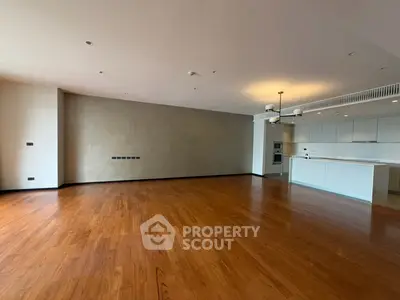 Spacious modern living room with open kitchen and elegant wooden flooring