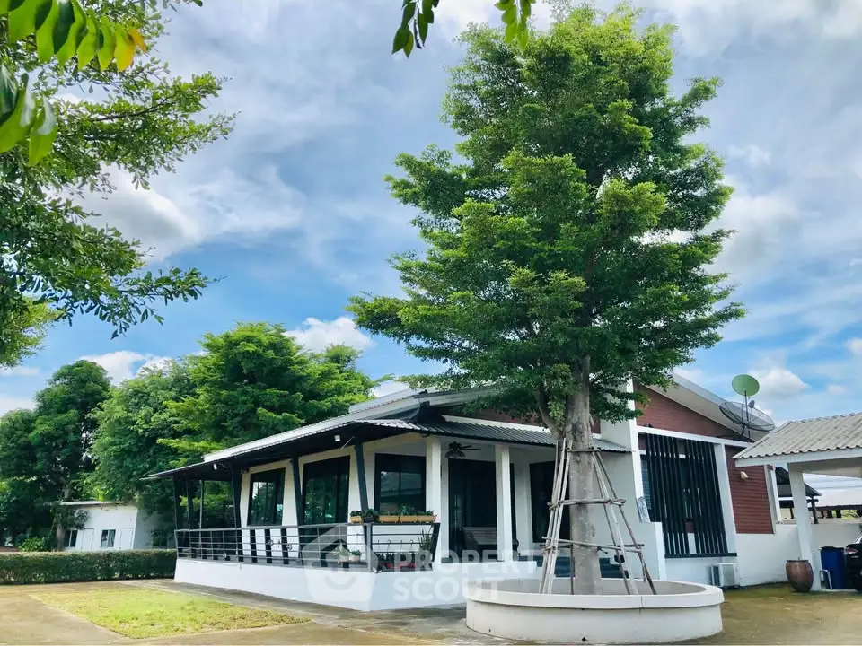 Charming modern house with lush greenery and spacious outdoor area, perfect for serene living.