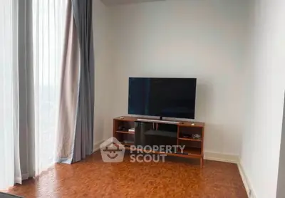 Modern living room with parquet flooring and sleek TV setup