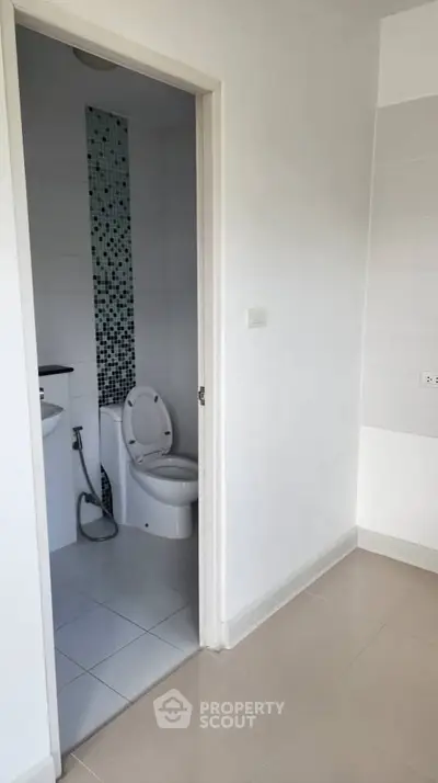 Modern bathroom with sleek design and mosaic tile accent wall