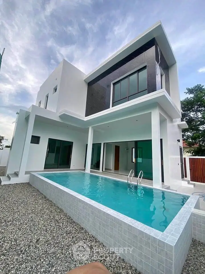 Modern two-story house with sleek design and private pool, perfect for luxury living.