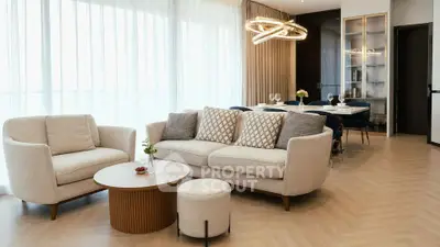 Elegant living room with modern furniture and stylish lighting in a spacious open-plan layout.