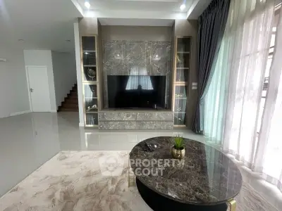 Luxurious living room with marble accents and modern decor, featuring a sleek entertainment center and plush carpeting.