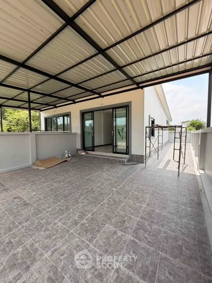 Spacious rooftop terrace with modern design and sliding glass doors, perfect for outdoor living.