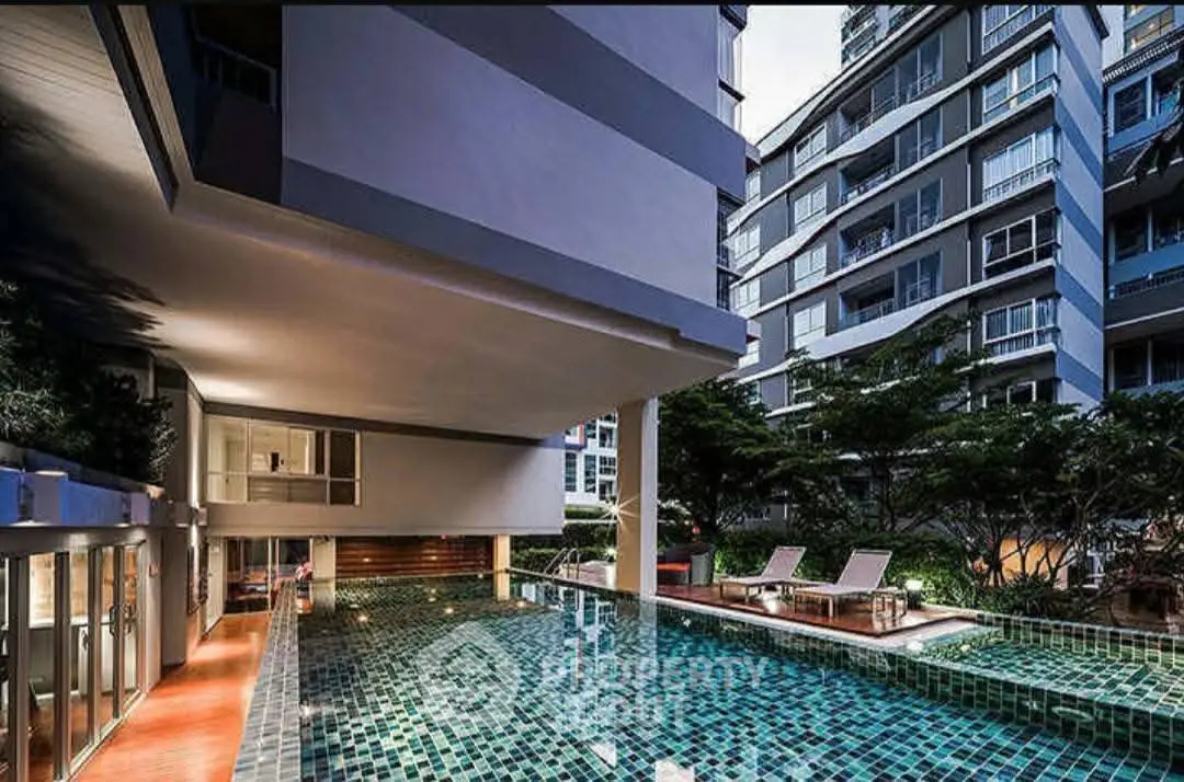 Luxurious condominium with modern pool and stylish architecture, perfect for urban living.