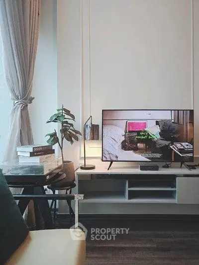Modern living room with stylish decor and flat-screen TV, perfect for relaxation.