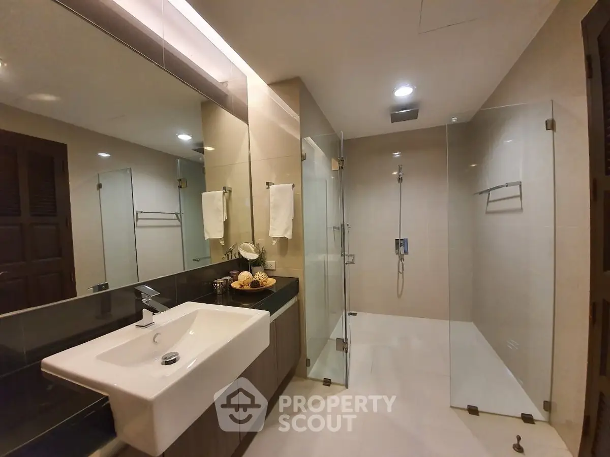 Luxurious modern bathroom with glass shower and elegant sink design