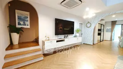 Spacious modern living room with wall-mounted TV and stylish decor