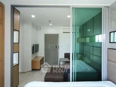 Modern studio apartment with glass partition and sleek furnishings