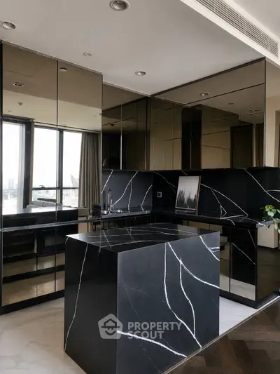 Luxurious modern kitchen with sleek black marble countertops and mirrored cabinets, offering a sophisticated urban view.