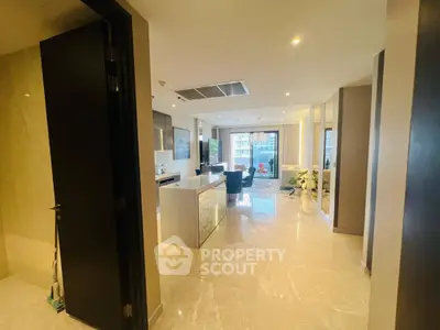 Luxurious open-plan kitchen and living area with modern design and marble flooring.
