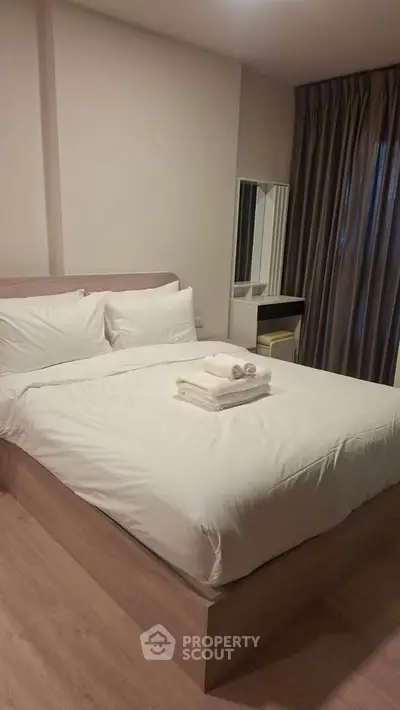 Cozy bedroom with modern decor and natural light, perfect for relaxation and comfort.
