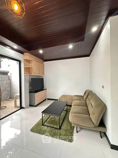 Modern living room with sleek furniture and natural light, featuring a cozy sofa and stylish decor.