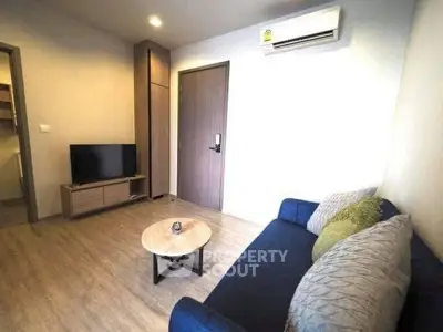 Modern living room with cozy sofa, TV, and air conditioning in stylish apartment.