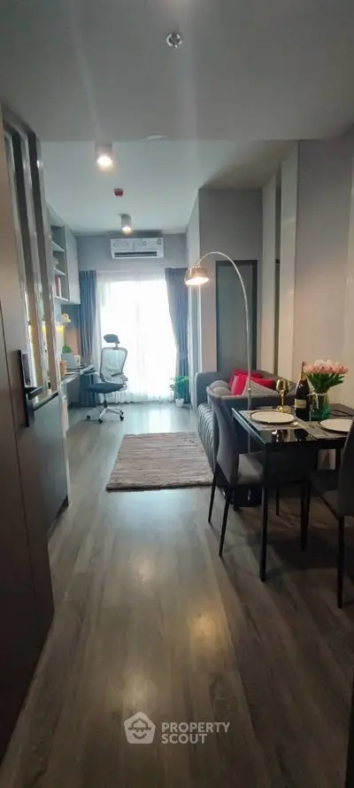 Modern living room with stylish decor and dining area in a cozy apartment setting.