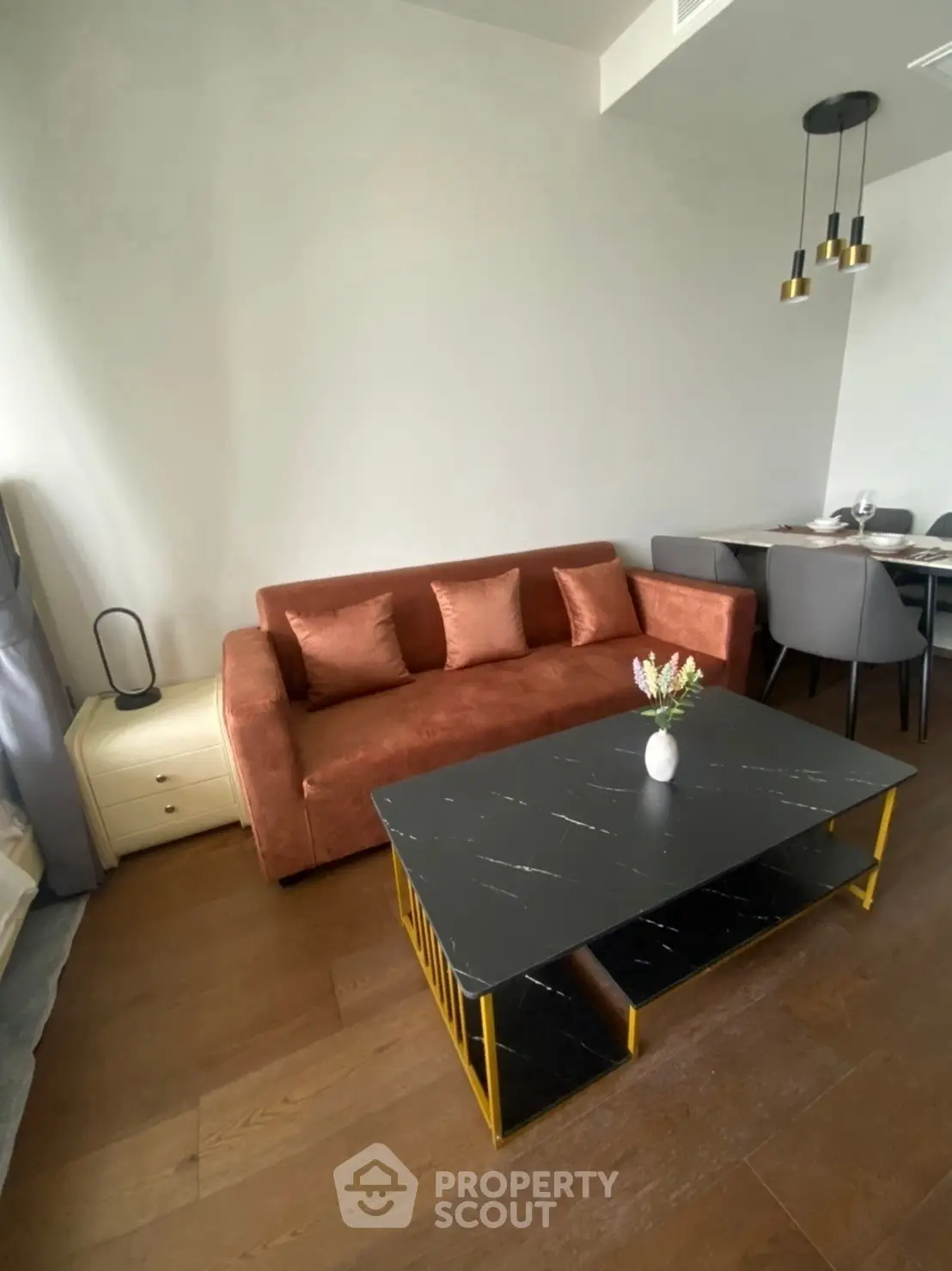 Modern living room with stylish brown sofa and elegant dining area