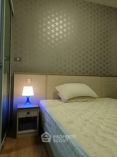 Cozy bedroom with modern decor and ambient lighting, perfect for relaxation.