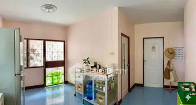 Charming kitchen with pastel walls and modern appliances, featuring a cozy open layout and ample natural light.