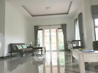 Spacious modern living room with sleek flooring and large windows for natural light.