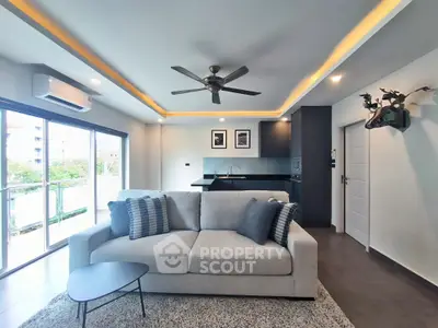 Modern living room with open kitchen, stylish decor, and balcony view in a contemporary apartment.