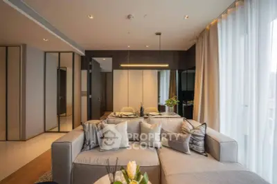 Luxurious modern living room with elegant decor and large windows for natural light.