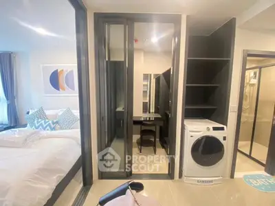 Modern bedroom with ensuite bathroom and washing machine, featuring sleek design and ample natural light.