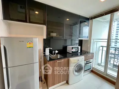Modern kitchen with appliances and balcony view in a stylish apartment