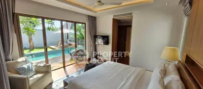 Luxurious bedroom with pool view and elegant decor in tropical villa