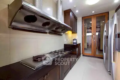 Modern kitchen with sleek appliances and gas stove in a stylish home