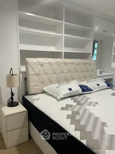 Luxurious bedroom with elegant headboard and built-in shelving, perfect for modern living.