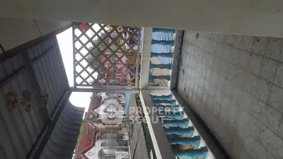 Spacious balcony with tiled flooring and decorative railing, perfect for outdoor relaxation.