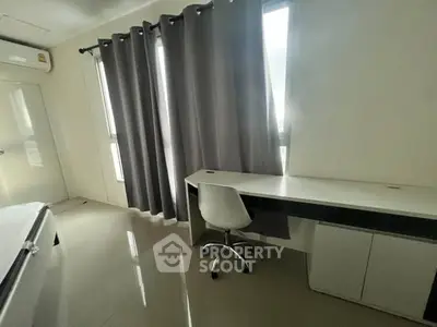 Modern study room with sleek desk and chair, large windows with gray curtains, and glossy floor.
