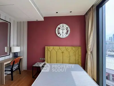 Modern bedroom with stylish decor and city view, featuring a unique clock and elegant furniture.