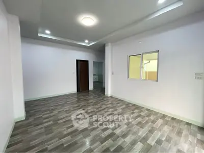 Spacious modern living room with sleek flooring and recessed lighting