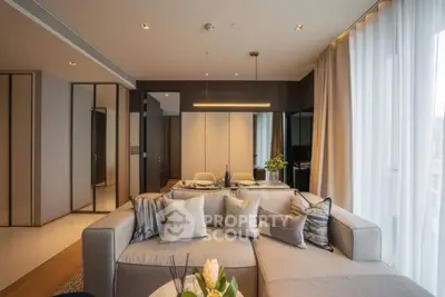 Luxurious modern living room with elegant decor and large windows.