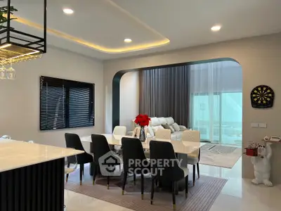 Luxurious open-plan dining and living area with elegant decor and modern furnishings.