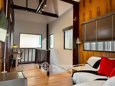 Charming loft-style living area with cozy seating and modern decor, perfect for relaxation and work-from-home setup.