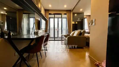 Modern living room with stylish furniture and balcony view in a luxurious apartment.