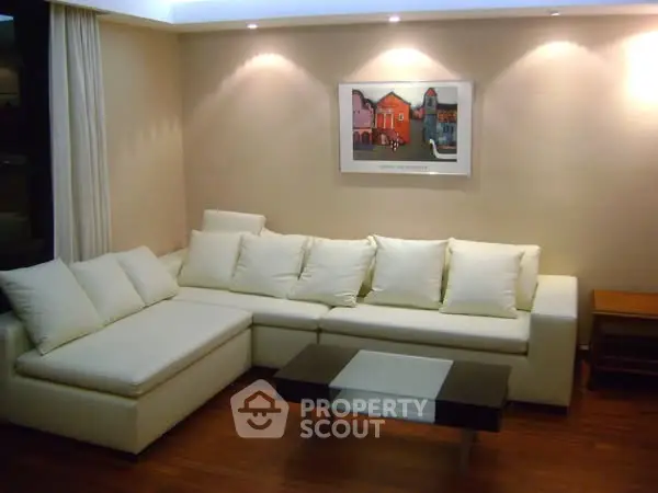 Elegant living room with modern white sectional sofa and stylish decor.