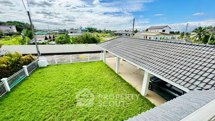 Spacious green garden with covered parking in suburban home
