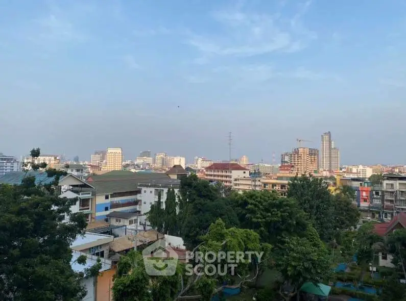 Stunning cityscape view from a high vantage point showcasing urban skyline and lush greenery.
