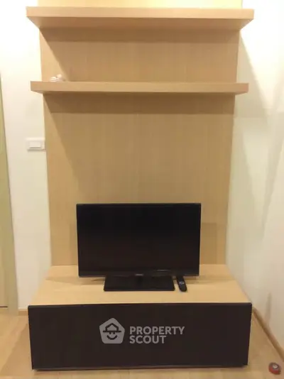 Modern living room with sleek TV stand and wall-mounted shelves, perfect for stylish urban living.