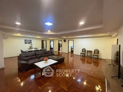 Spacious living room with elegant wooden flooring and modern furniture
