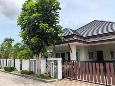 Charming single-story home with modern roof and lush garden in serene neighborhood.