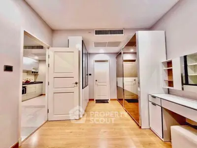 Spacious modern interior with wooden flooring and sleek white furniture, perfect for stylish living.