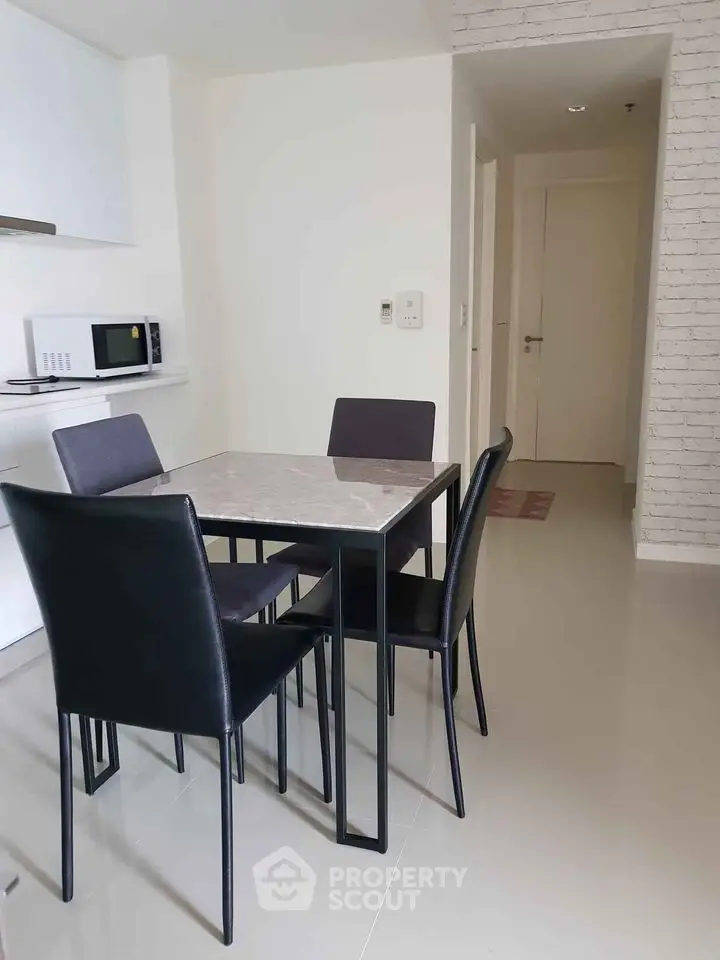 Modern dining area with sleek table and chairs in minimalist apartment